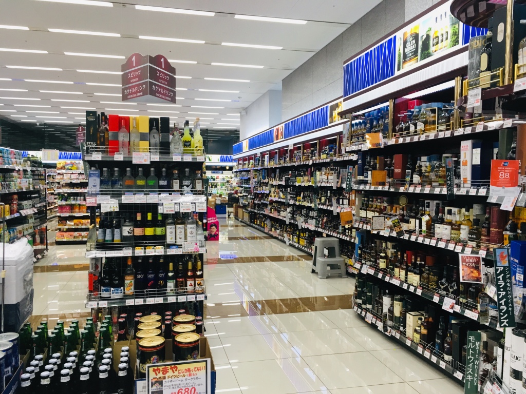 A liquor store, Cave de Yamaya, in Shibuya. Shelves are lined with various spirits and alcohol. 